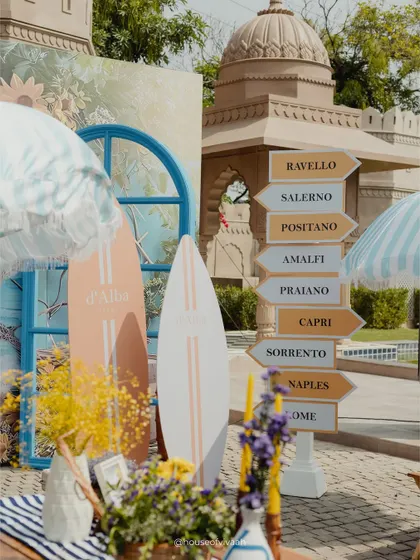 Transporting guests to the Amalfi Coast without leaving Jaipur. This photo from a Positano-themed Mehendi shows how I use specific, sensory details like directional signs, surfboards, and striped umbrellas to build a completely immersive world. It’s about creating a vibe that is playful, sunny, and full of discovery.