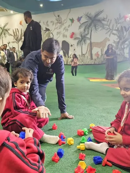 Mr. Gopichand engaging with young children at the MVN facility, showcasing our commitment to grassroots development.