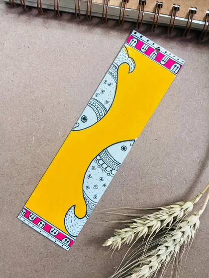 A Madhubani bookmark with the traditional fish design, symbolizing good luck and abundance.