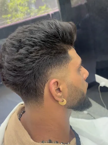 A textured haircut with a high fade, a variation of a modern crop.