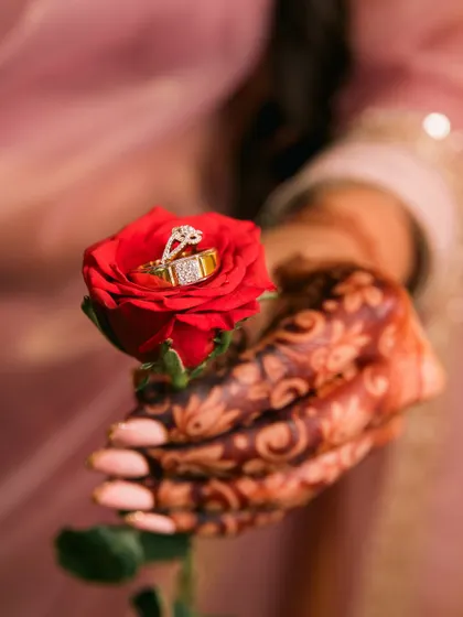 We believe the details tell the story. This creative shot focuses on the engagement rings, nestled in a red rose, symbolizing the promise and romance of the day.
