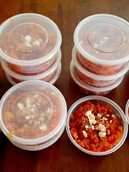 More of our delicious carrot halwa, portioned into individual containers for easy distribution at a party. It's a hassle-free way to serve dessert.