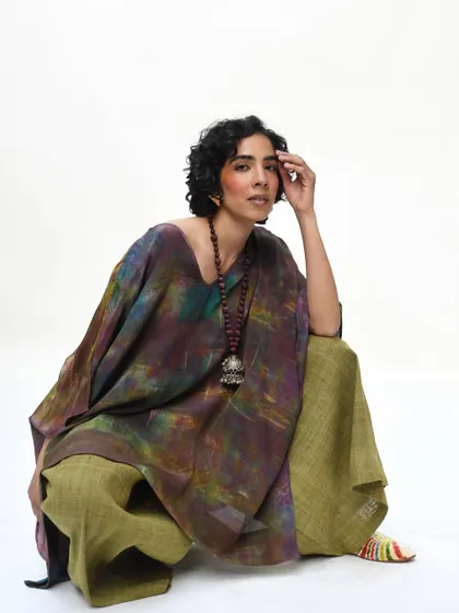 A powerful, direct portrait for Wandering Silk. The model's confident pose and the rich, earthy tones of her outfit are captured straight from the camera, showcasing a raw and untouched beauty.