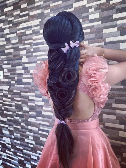 An intricate hairstyle created on a mannequin, featuring multiple hair roses and butterfly clips. Practicing on mannequins allows for perfecting these advanced and delicate techniques.