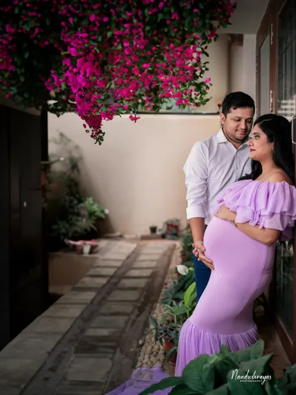 A quiet, intimate moment shared on a garden patio. The bougainvillea flowers add a touch of vibrant color to this tender couple's portrait.