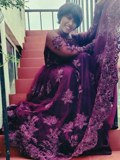 A duplicate of a previous image, but it's a great shot from the purple gown photoshoot, showing a happy, relaxed moment.