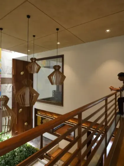 The design of Ashraya Residence is structured along two axes to ensure cross-ventilation and vertical connectivity. This view from the upper lounge shows how the home is visually and spatially connected, fostering a sense of openness.