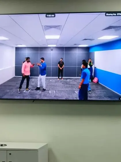 Our Tai Chi workshops can be conducted for large groups and even broadcasted for remote teams, as seen here during a corporate session.