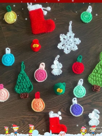 A colorful assortment of my handmade Christmas tree ornaments laid out. I offer a wide variety of shapes and colors, including trees, baubles, snowflakes, and angels.