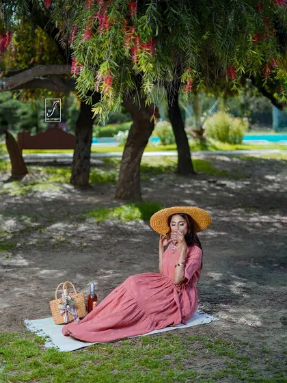A wider shot of the picnic setup, establishing the peaceful and idyllic atmosphere of the entire fashion story.