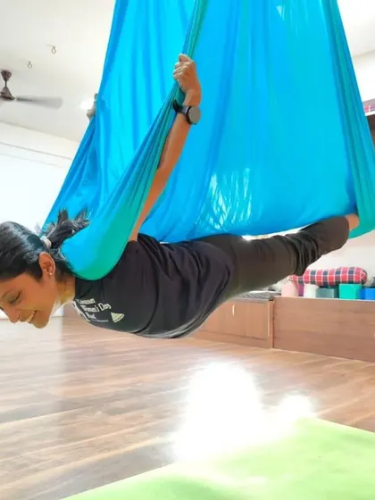 Flying high in our studio. Aerial yoga builds upper body and core strength while allowing you to explore poses in a completely new way.