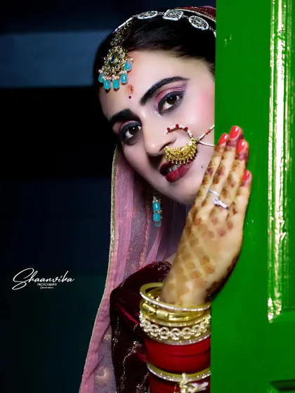 A creative shot of the bride peeking from behind a door, her expressive eyes drawing you into the photo.