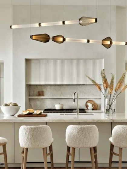 The Luna Kaleido series in a bright, modern kitchen. The linear form is ideal for illuminating a long island, while the glass elements add a touch of color and texture.