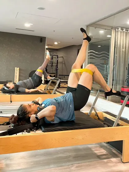 Adding a resistance band during this Reformer bridge exercise intensifies the work on the glutes and hamstrings, sculpting and strengthening the posterior chain.