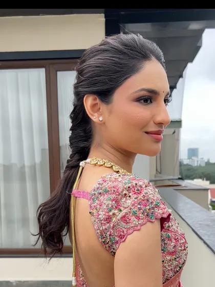 A side profile of a bride with a modern, textured fishtail braid, showing how it elegantly frames her face.