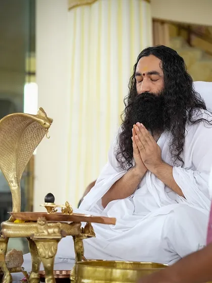 An instructor performs the Rudra Puja, a powerful ceremony dedicated to Lord Shiva. The cobra statue symbolizes the awakened kundalini energy, which is associated with higher states of consciousness.