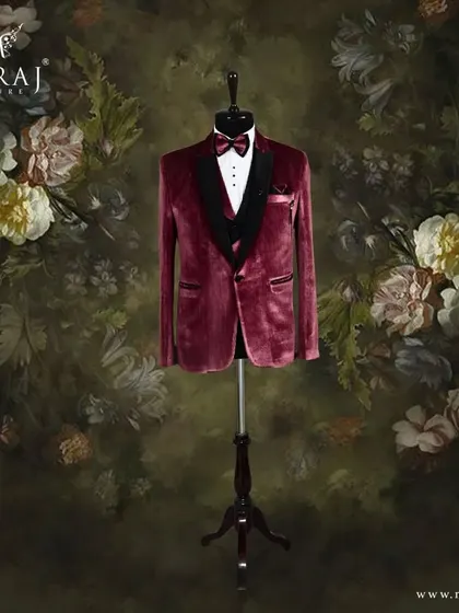 For the groom who commands attention, I designed this striking three-piece tuxedo. The rich red velvet jacket, paired with a classic black satin lapel and bow tie, offers a bold and sophisticated look for a reception or formal event.
