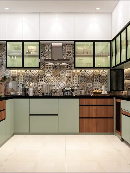 A full view of the modern kitchen with pastel green and wood cabinets. The layout is designed for efficiency, with the hob, sink, and built-in ovens creating a perfect work triangle.