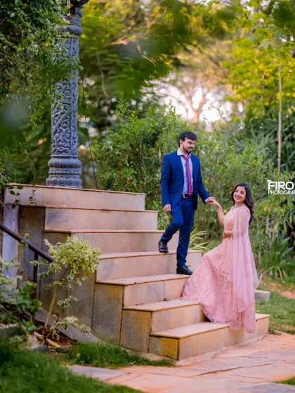 A "leading the way" shot on a garden staircase. This pose is great for creating a sense of story and movement in your pre-wedding photos.
