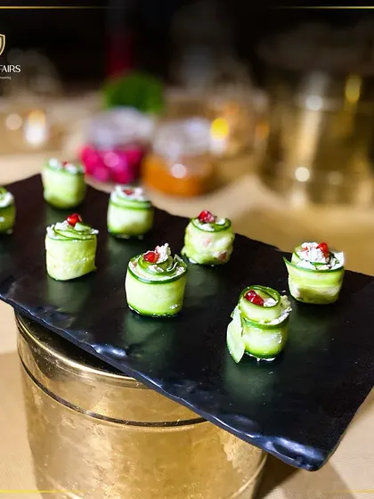These cucumber rolls are a light and refreshing appetizer option. Thinly sliced cucumber is wrapped around a creamy filling and garnished with pomegranate seeds, offering a burst of freshness.