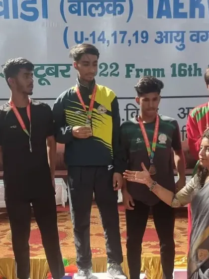 An official congratulating my student on his victory. His hard work was recognized by everyone.