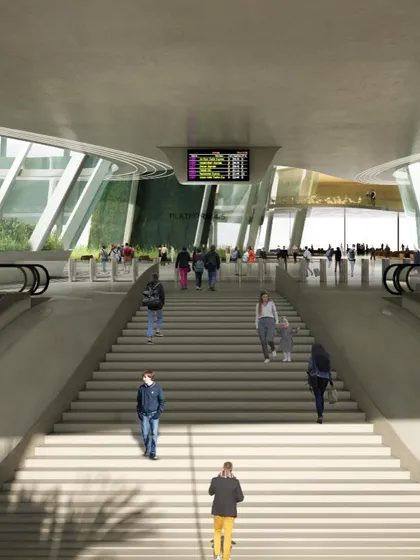 Passengers ascending the main staircase, a central feature of the station's circulation design.