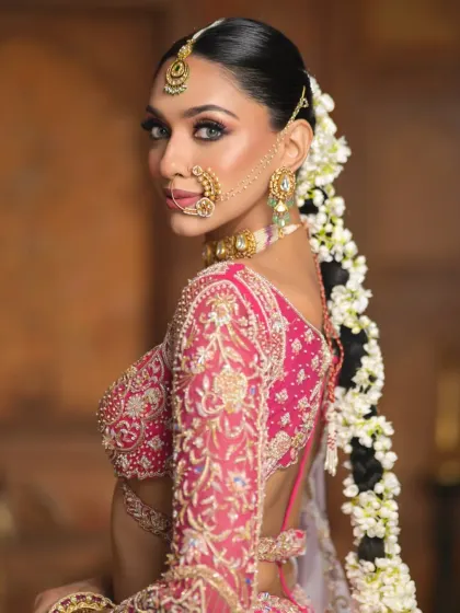 This image shows the intricate connection between the gajra braid and the model's shoulder, emphasizing the length and flow of the hairstyle as part of the complete look.