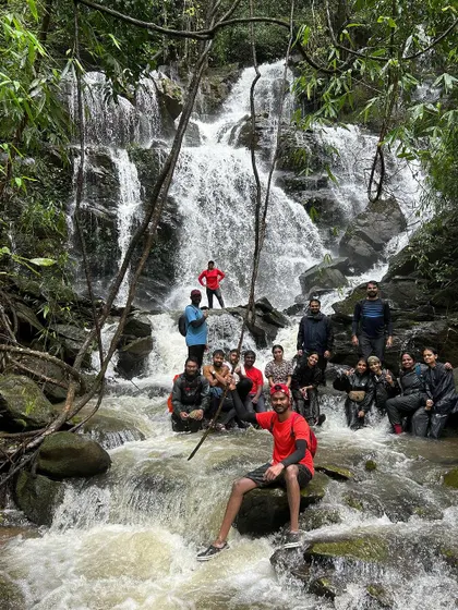 The whole group relaxing in a waterfall. It's the perfect way to cool down and have fun after a challenging trek.