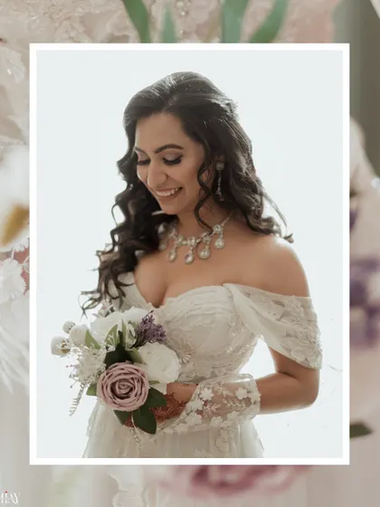A close-up portrait of the Christian bride, her smile radiant as she holds her bouquet.