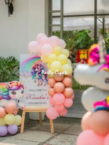 The welcome entrance for Kashni's unicorn party. A personalized sign and a unicorn-themed balloon arrangement greeted guests as they arrived.