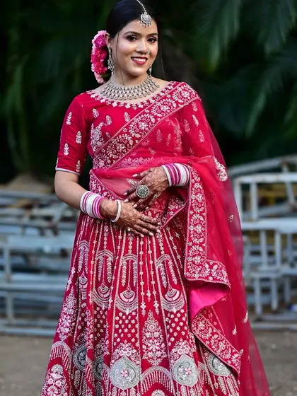 This beautiful pink bridal lehenga is perfect for a day wedding. The silver embroidery stands out against the vibrant pink velvet.