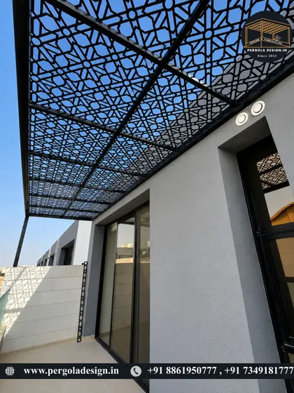 A sleek and modern laser-cut pergola attached to a contemporary building. The intricate pattern adds a touch of sophistication and provides partial shade for the balcony space below.