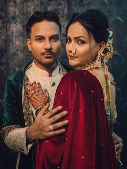 A powerful and intimate royal-themed couple portrait, showcasing a deep connection with moody, cinematic lighting and rich, traditional attire.