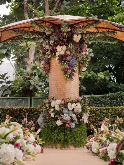 The stunning floral-adorned backdrop for the engagement, which was handmade by 18 women weavers from North Karnataka.