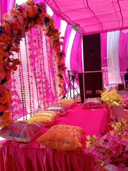 Another angle of the tented Mehndi decor, highlighting the floral arch and the traditional beaded curtains that add a sparkling touch to the setup.