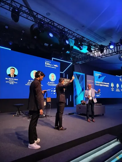 Our team setting up the stage for a panel discussion at the SAP NOW AI Tour. We ensure the layout is perfect for both the panelists and the audience view.