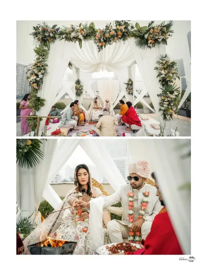 A wide shot of the rooftop wedding mandap, showing the beautiful floral decor and the intimate setting of the ceremony.