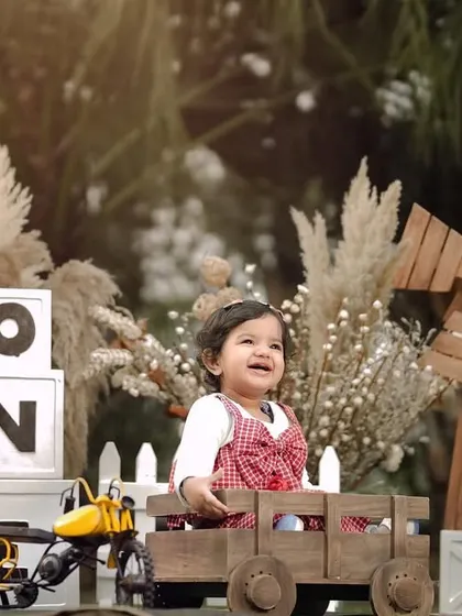 A joyful smile from the birthday boy. His happiness is contagious in this fun, rustic-themed first birthday photoshoot.