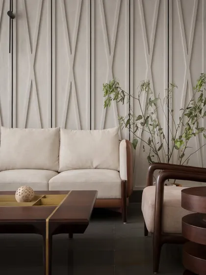 Another view of the living area, showing the sculpted wall paneling and warm, earthy tones. The design balances restraint with character, creating a comfortable and inviting space.