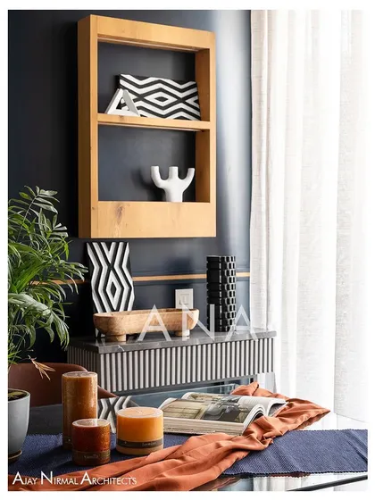 A close-up on the dining table decor in Apartment 704. The styling combines modern geometric patterns with natural elements, reflecting the overall design concept of the home.