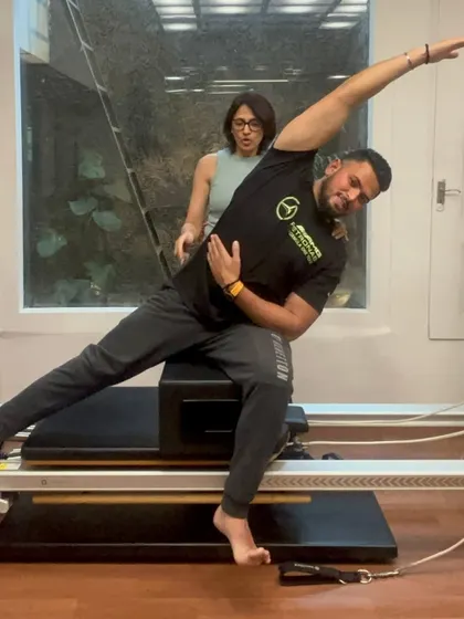A graduate of our PAI Reformer Instructor course demonstrates his skills, showcasing the strength and knowledge gained through our training.
