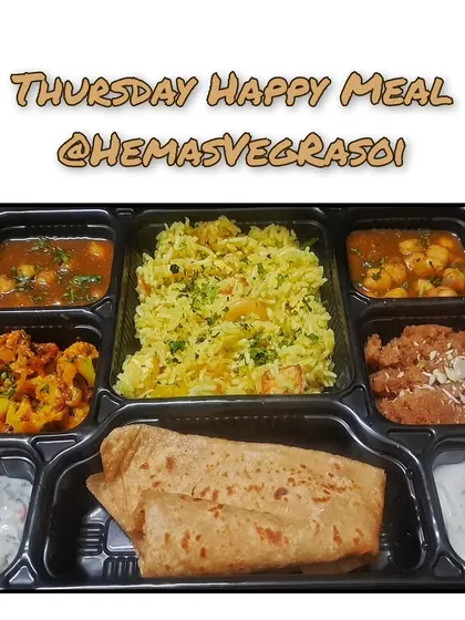 My Thursday Happy Meal, packed and ready to bring a smile to your face. This complete vegetarian thali includes Paneer Pulav, Raita, Chole Gravy, Gobi Sabji, and a comforting Wheat Sheera, all made with the freshest ingredients.