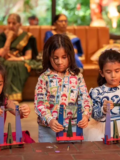 Deep in concentration, these young astronauts are carefully constructing their rocket launchpads, ensuring their creations are ready for flight.