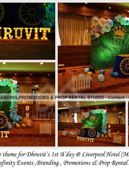 We designed this simple yet regal Royal Prince theme for a first birthday at the Liverpool Hotel. The decor features a lush grass wall backdrop, a charming royal carriage prop for the cake, and marquee letters spelling out the birthday boy's name, all tied together with a blue and white balloon garland.