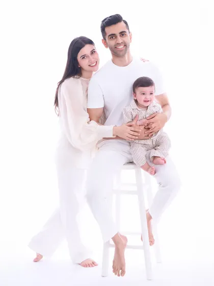 Our timeless all-white studio style is perfect for creating modern, clean, and elegant family portraits. By keeping the background and wardrobe simple, we ensure that the love and connection between this family of three remain the central focus.