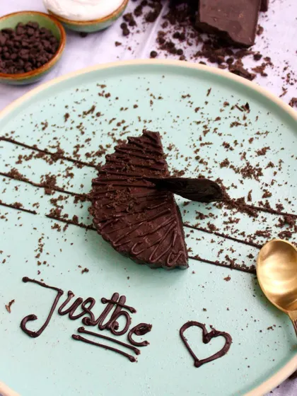 A slice of our rich chocolate cake, beautifully plated. This shows how our desserts are not just for takeaway but are also a wonderful dine-in experience.
