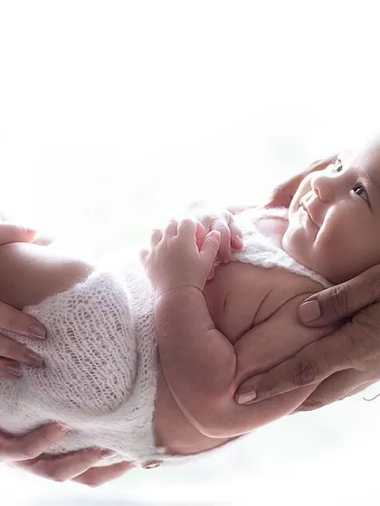 So small, they fit perfectly in your hands. This pose is a powerful reminder of just how tiny they once were, a treasured keepsake of their first days.