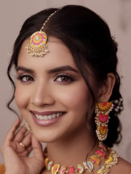 A happy, close-up shot that highlights the soft glam makeup and the subtle pop of colour, proving that mehendi makeup can be both playful and chic.