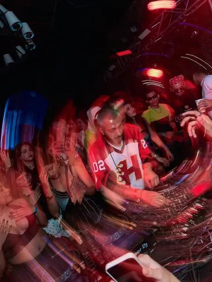 A blurry, action-filled shot from the Tahiti event, conveying the motion and energy of the dance floor.