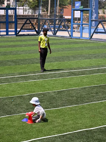 A playgroup student works on a color-sorting game with cones.